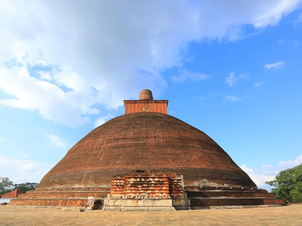 Jetavanaramaya brick stupa beneath blue skies in Anuradhapura