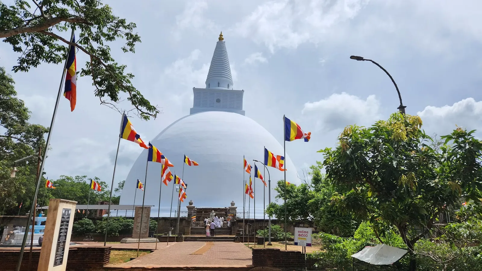 Ruwanwelisaya temple entrance and Buddhist flags in Anuradhapura