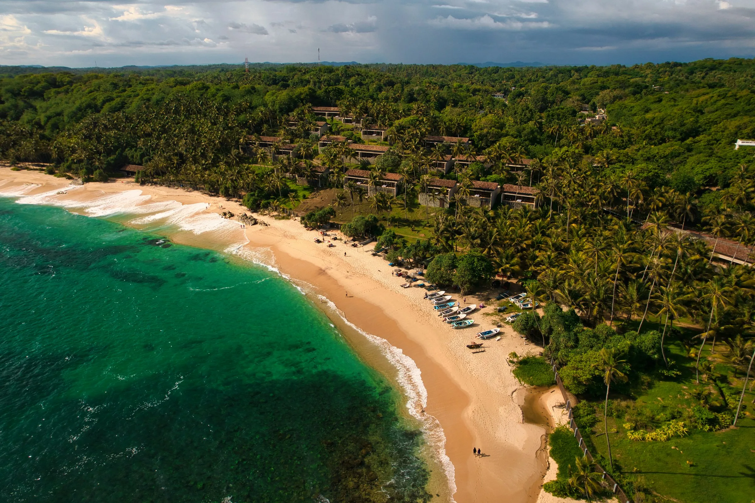 Aerial view of Tangalle's palm-lined beach and turquoise sea in Sri Lanka